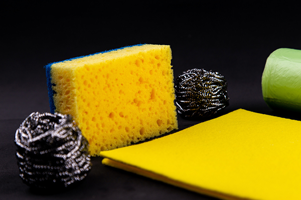 a sink getting cleaned with sponge