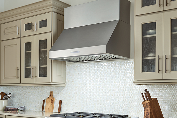 a person holding a range hood cover