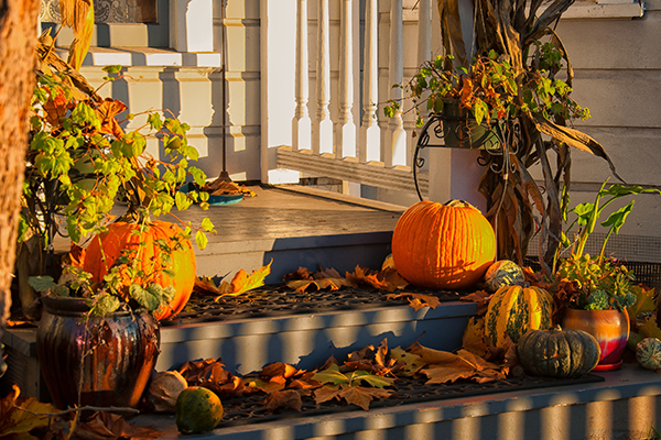 leaves and pumpkin outside a house entrance